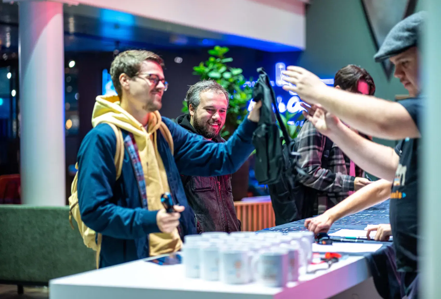 Attendees grabbing swag at React Brussels