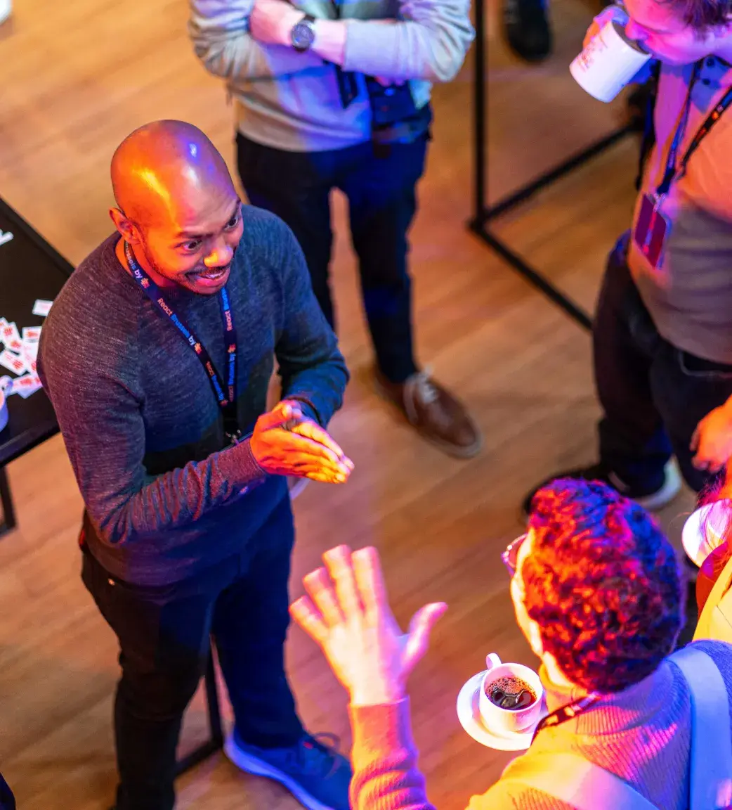 Speaker talking with attendees at React Brussels